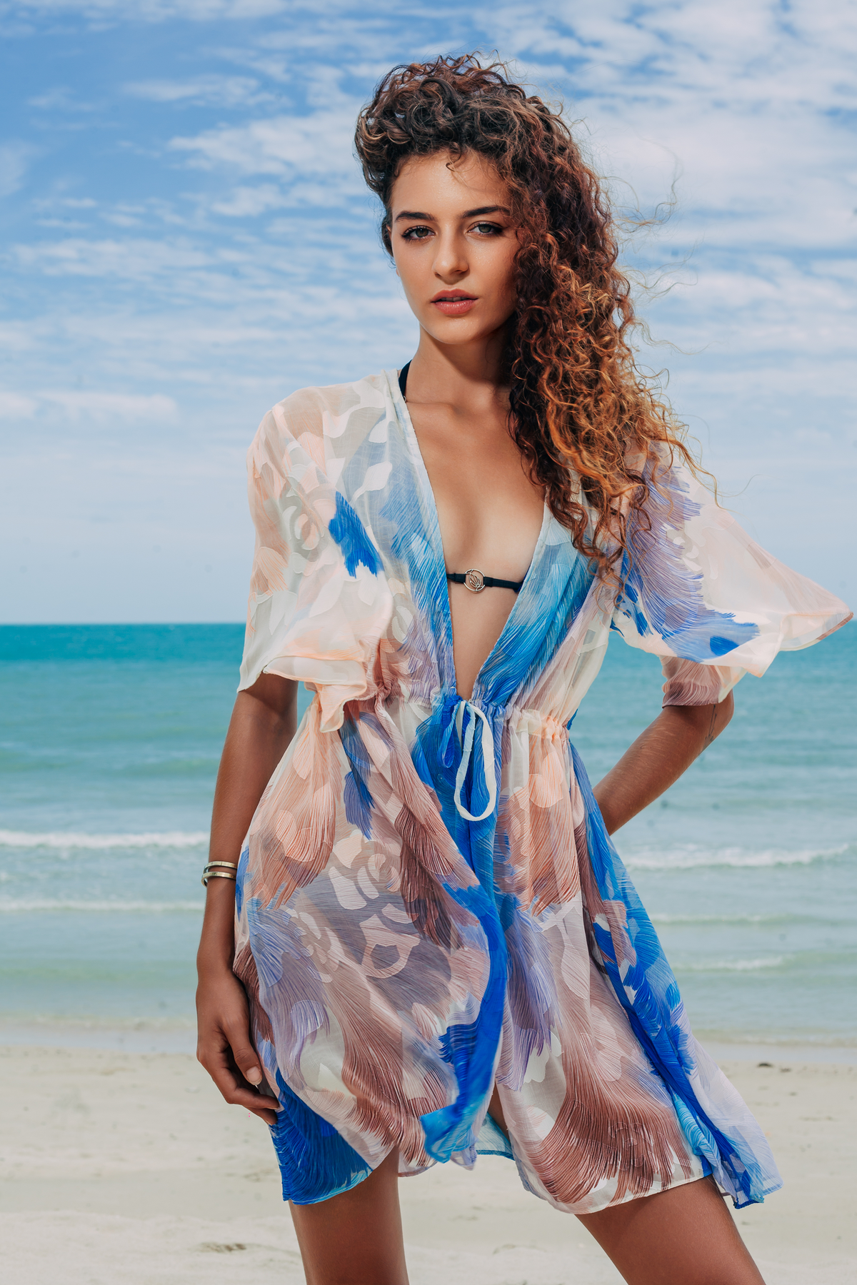 Aveline Mini Tunic in blue and white print, front view on the beach