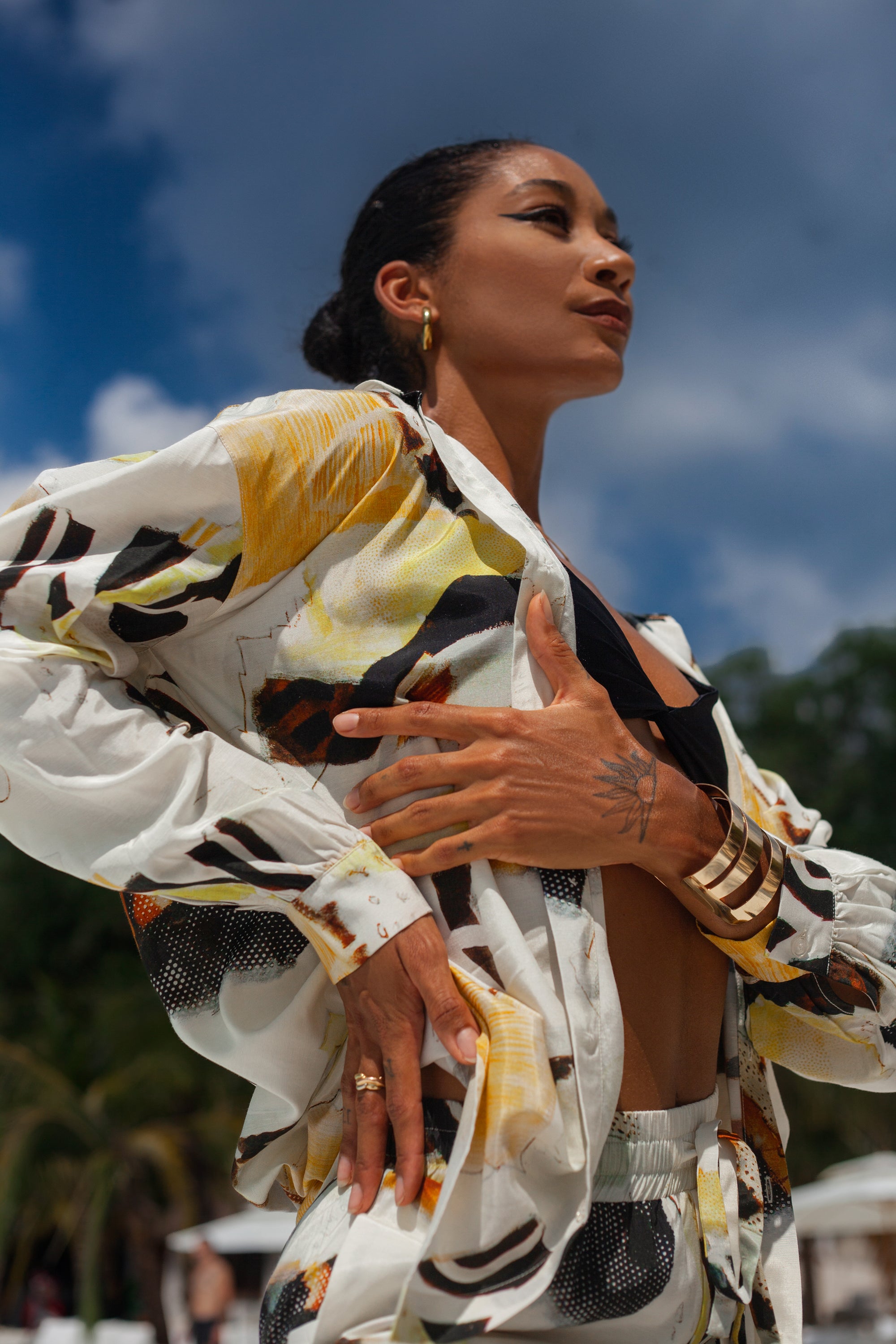 Solea shirt in abstract print worn open, lightweight resortwear look