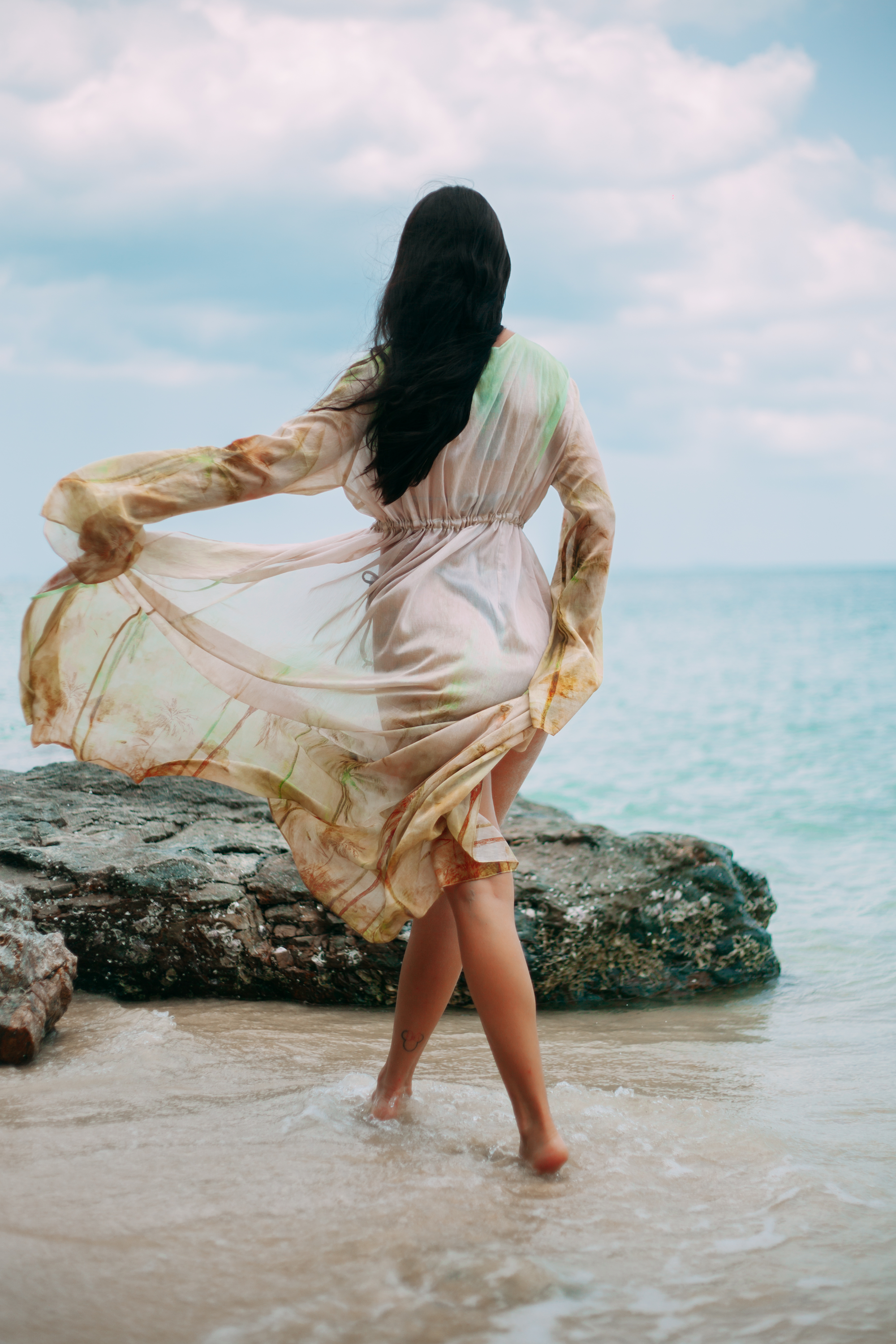 Back view of Selara Maxi Tunic with flowing sleeves and tropical print