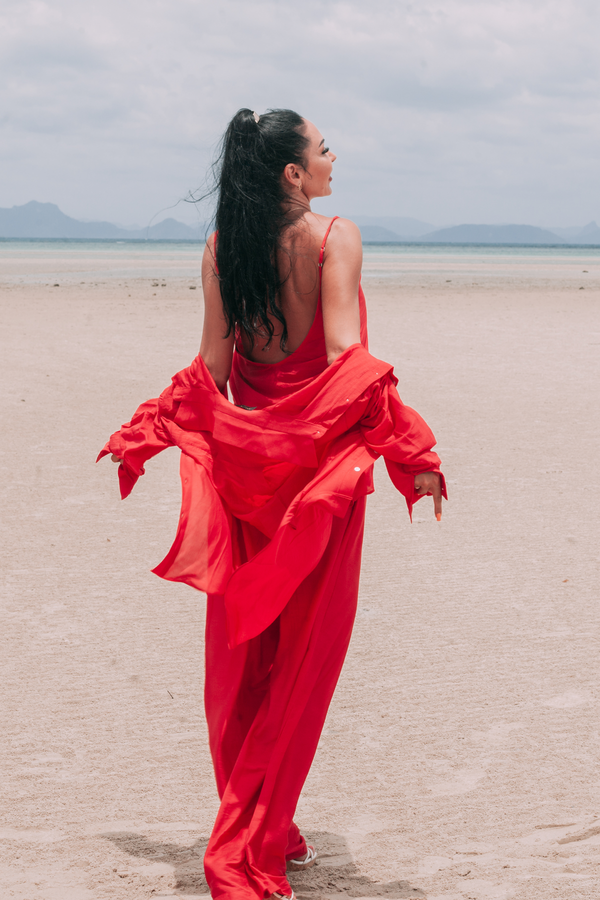 Carmine red resort set with open-back asymmetric top, adjustable straps and flowing shirt by INNEVIA