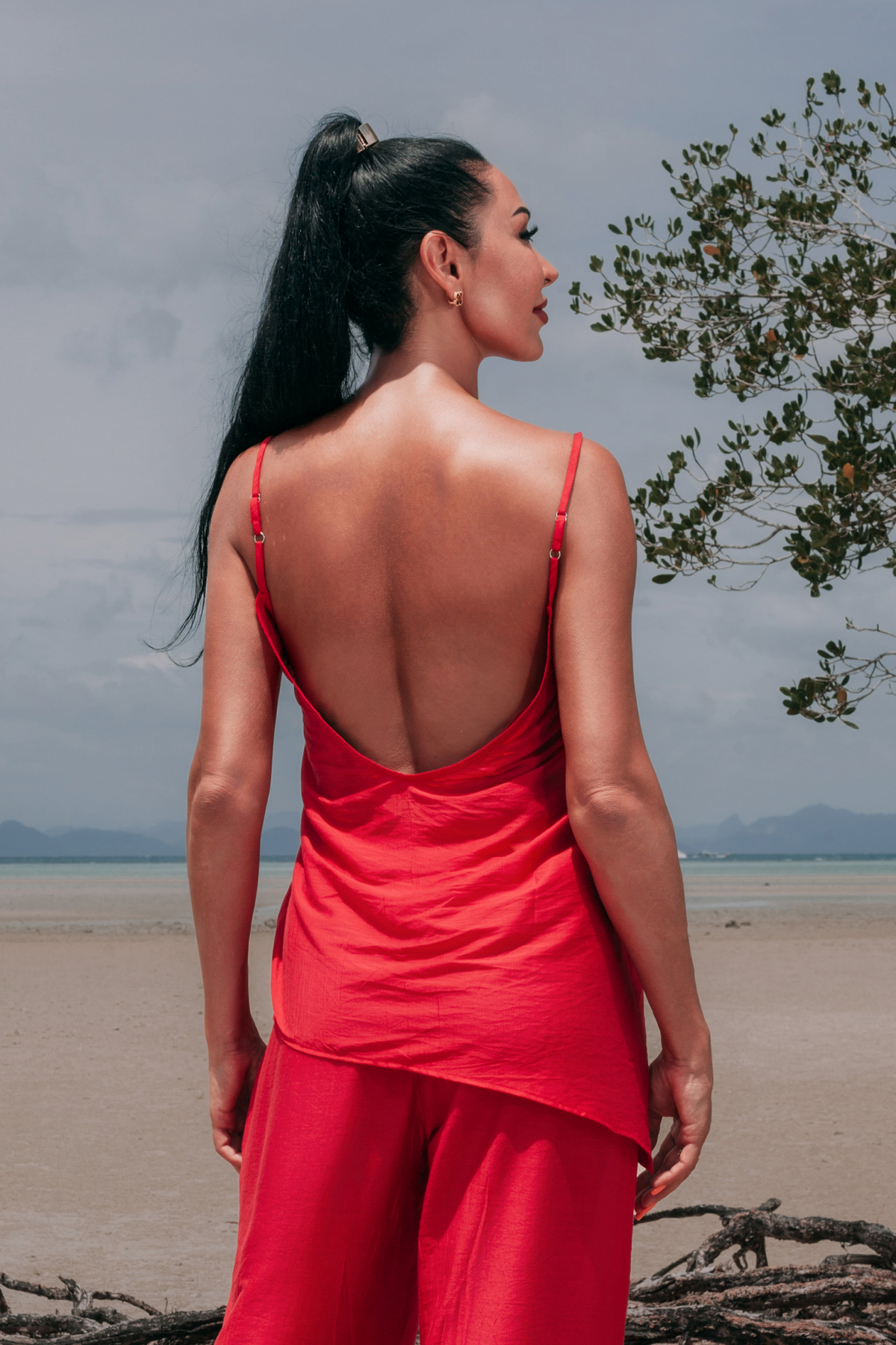 Back view of Carmine Top by INNEVIA in deep red, highlighting the low back, adjustable slim straps and relaxed flowing fit