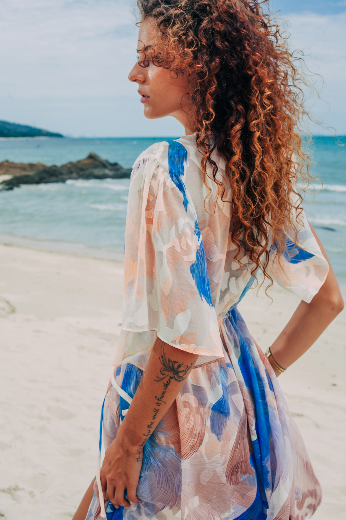Aveline Mini Tunic in blue and white print, side profile on the beach