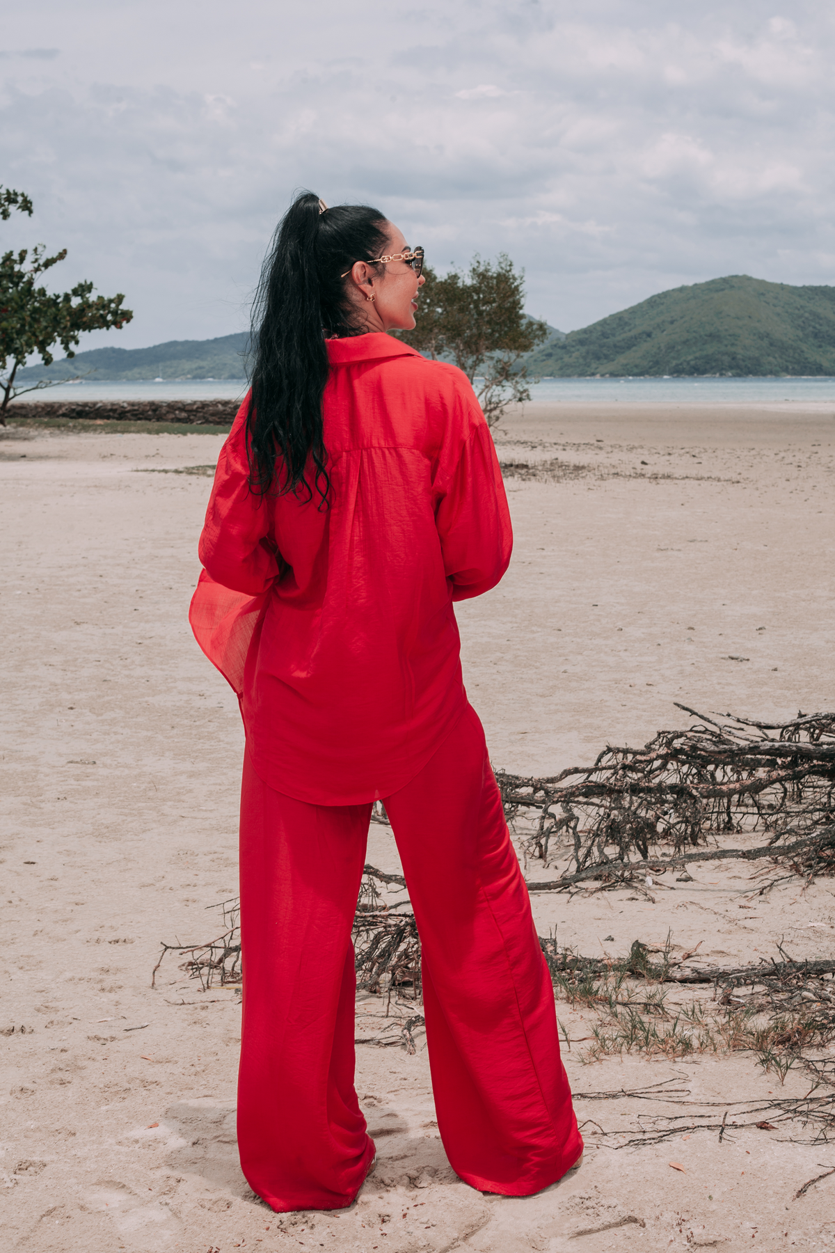 Back view of Carmine red resort set with relaxed button-down shirt and wide-leg trousers by INNEVIA