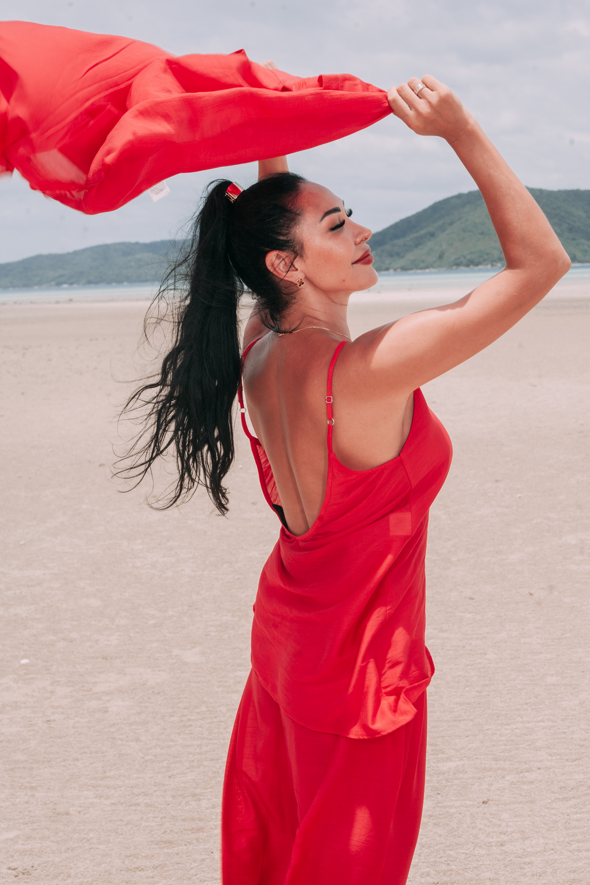 Carmine Top and matching deep red trousers by INNEVIA, styled with a coordinating flowing shirt for a relaxed seaside resort look