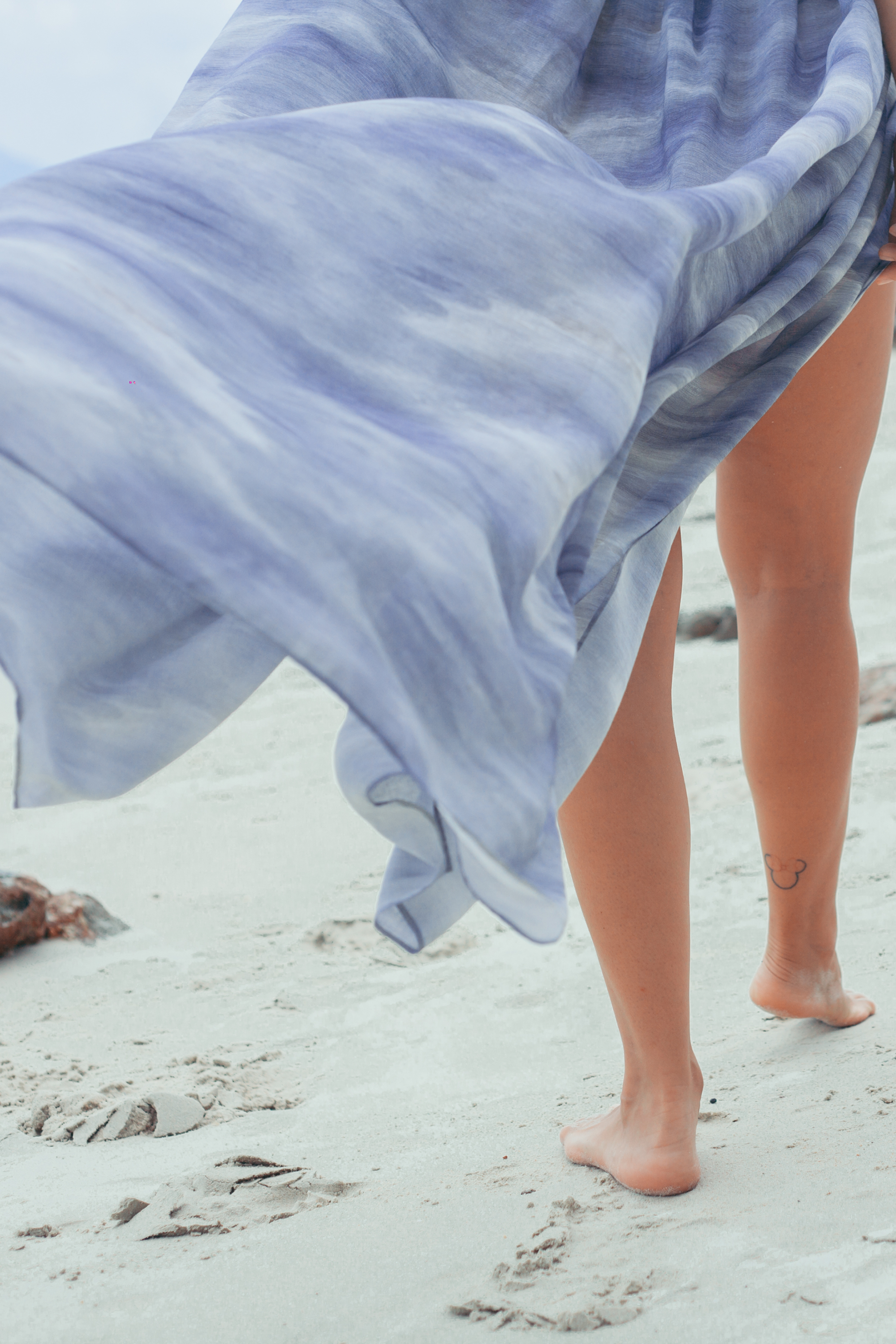 Lightweight Elara Wrap Maxi Skirt flowing in the ocean breeze, airy resort skirt in soft blue tones