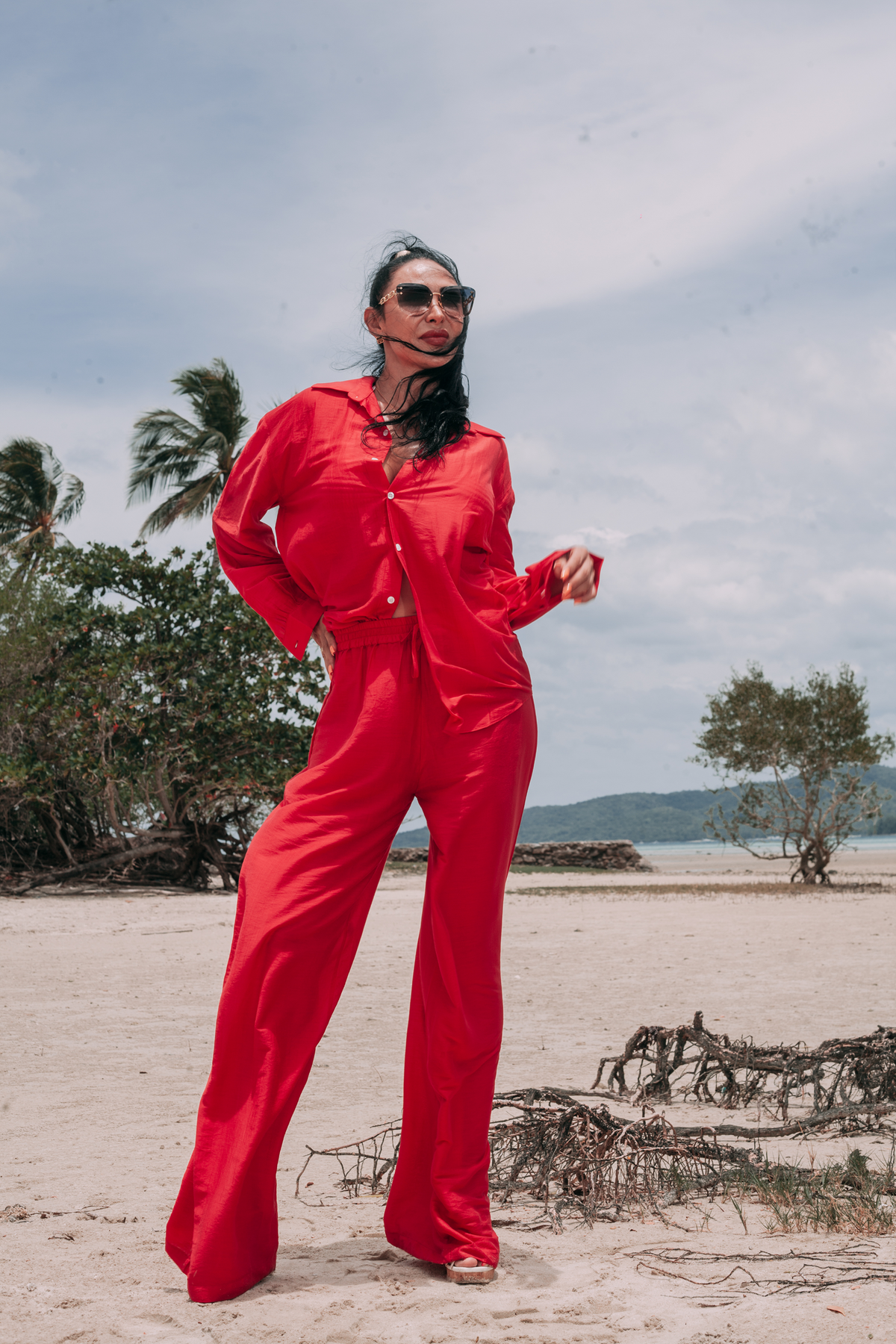 Full-length resort look featuring Carmine Relaxed Shirt and matching Fluid Wide-Leg Pants by INNEVIA on a tropical beach